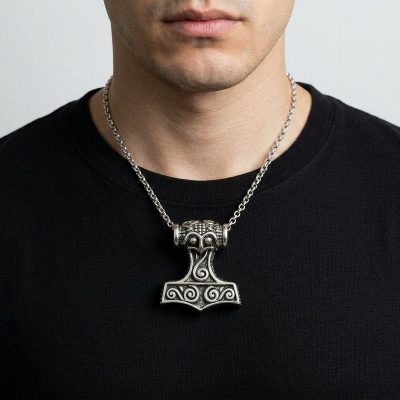 Thor Hammer Sterling Silver Pendant worn by a man in a black shirt, with its spiral relief and barrel bail visible