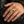 Solid 14k gold skull ring with sapphire eye and diamond tooth alternate worn view for scale