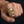 Solid 14k gold skull ring with sapphire eye and diamond tooth worn on hand for scale