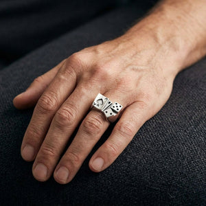 Ace of spades and dice silver ring worn on a hand