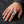 Ace of Spades skeleton hand silver ring with an open single-thumb shank, worn on a man's hand