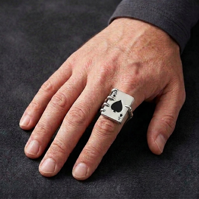 Ace of Spades skeleton hand silver ring with an open single-thumb shank, worn on a man's hand