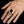 Gold-plated amethyst halo ring shown larger on a complete hand with five visible fingers