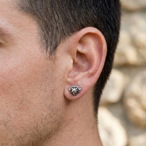 Bison silver stud earring on a man’s ear in close-up