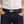 Black crocodile hornback ratchet belt worn with dark jeans and an off-white shirt