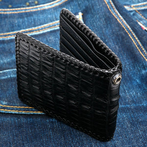 Black Crocodile Tail Leather Bifold Wallet, standing front on denim