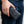Black Gothic Cross Stingray Leather Wallet held at the waist, with the upper attachment point hidden by the hand