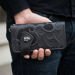 Black Stingray Skull Concho Long Biker Wallet, held at hip level