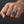 Blue-stone medieval cross silver ring worn on a light-skinned man's clenched fist