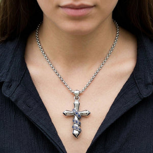 Blue CZ Wrapped Cross Sterling Silver Pendant styled on a silver chain with a dark shirt