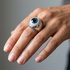 Blue Evil Eye Sterling Silver Adjustable Ring, worn on an adult model
