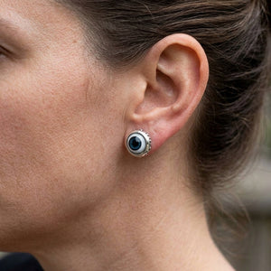 Blue Evil Eye Sterling Silver Stud Earrings, worn on an adult model