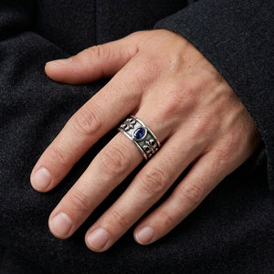 Blue Sapphire CZ Fleur-de-Lis Sterling Silver Band Ring worn at a natural scale on a man's hand
