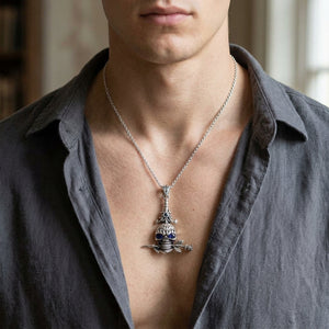 Blue Sapphire-Eye Skull and Rose Sterling Silver Pendant, worn on the neck with collarbones, shoulders and upper chest visible