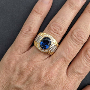 Blue Stone Gold and Silver Watch Band Ring, worn on an adult hand