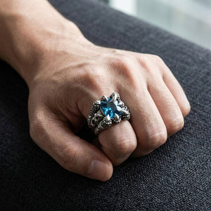 Blue Topaz Eagle Claw Sterling Silver Ring worn on an adult hand