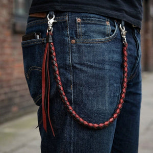 Red and black braided leather wallet chain clipped to jeans for scale