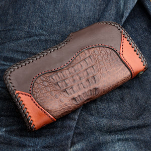 Horizontal rear view of the crocodile panel, stitched border and braided edge.