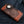 Brown crocodile wallet on denim with raised scales, floral leather ends and a round concho.
