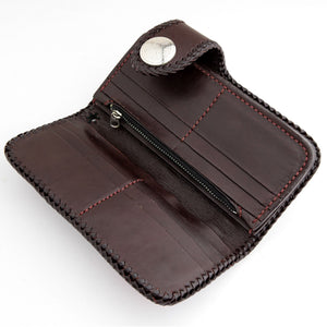 Open brown leather wallet with card slots, bill sections and a central zip compartment.