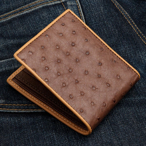 Brown Quill Ostrich Bifold with Tan Edging showing natural quill marks across the brown front at an angle.