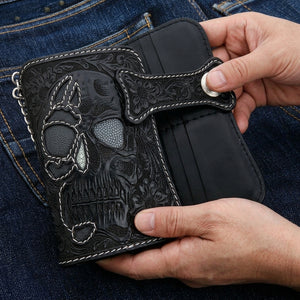 Carved Skull Stingray and Calfskin Biker Wallet, held in an adult hand