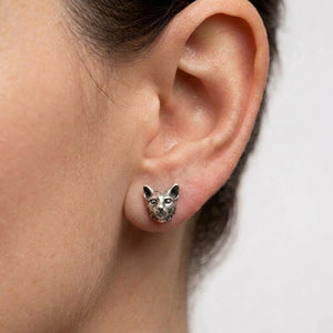 Cat Head Sterling Silver Stud Earrings worn on an adult ear