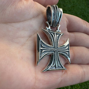Chopper Maltese Cross Sterling Silver Pendant, cross and bail angled in palm