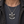 Chopper Skull and Piston Sterling Silver Pendant with skull, pistons and CHOPPER banner over a dark shirt.