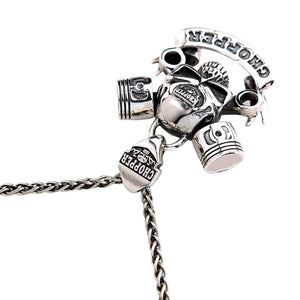 Chopper Skull and Piston Sterling Silver Pendant shown in wrenches banner angle view.