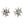 Boucles d'oreilles puces Croix de Fer en argent sterling et oxydes de zirconium transparents. Les branches évasées de la croix et les sertissages surélevés d'oxydes de zirconium sont visibles sous un angle bas.
