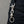 Clear-Eye Skull Sterling Silver Keychain, clipped to a black denim belt loop