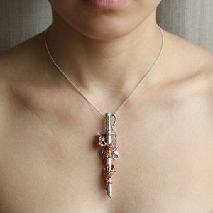 Copper Dragon Sterling Silver Sword Pendant, worn on the neck with collarbones, shoulders and upper chest visible