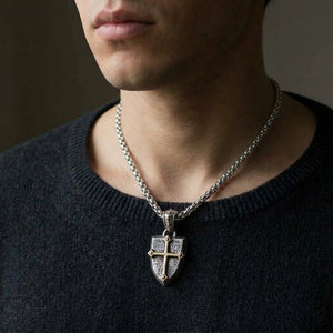 Silver shield pendant with brass cross worn on a 4 mm sterling silver chain