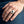 Anillo ajustable de plata esterlina con globo ocular azul oscuro, usado en un dedo medio en un primer plano natural de la mano