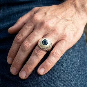 Dark Blue Eyeball Sterling Silver Adjustable Ring, worn on one middle finger in a natural hand close-up