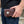 Dark Red Tooled Leather Indian Head Biker Wallet, held at hip level