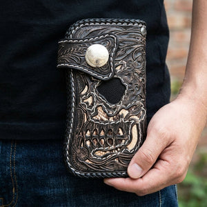 Demon Skull Cobra and Stingray Leather Biker Wallet, held at hip level