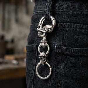 Double Skull Sterling Silver Keychain, hanging from a denim belt loop