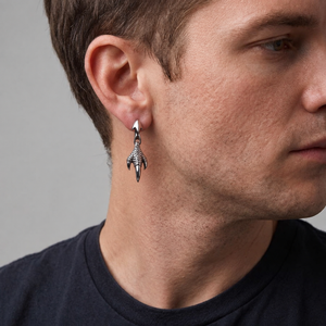Dragon claw silver drop earring worn on a male model