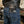 Long tooled leather and stingray wallet inserted into a rear jeans pocket beneath a black leather jacket, with the dragon concho visible.
