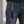 Chaveiro de dragão em prata e couro trançado preto pendurado em um passador de jeans, com quatro pontas com ponteiras de prata