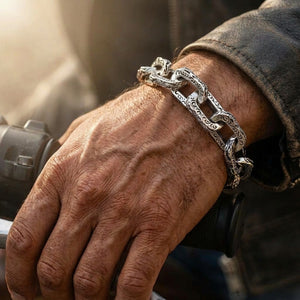 Dragon Link Sterling Silver Bracelet, worn on a medium-brown wrist with the dragon-head clasp visible