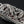 Close-up of the raised dragon carving on the silver multi-tool body