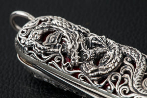 Close-up of the raised dragon carving on the silver multi-tool body