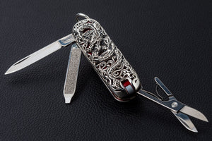 Dragon-engraved silver multi-tool with knife blade, file and scissors extended