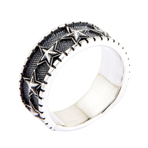Embossed Star Sterling Silver Band Ring. Notched band oblique.