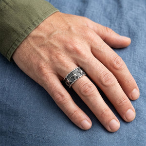 Embossed Star Sterling Silver Band Ring worn on an adult hand.