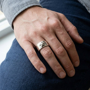 Faceted Star Sterling Silver Band Ring worn on an adult hand.