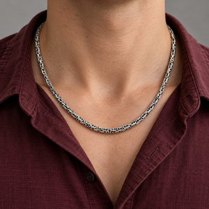5mm Byzantine Sterling Silver Chain Necklace around the neckline of a burgundy shirt.